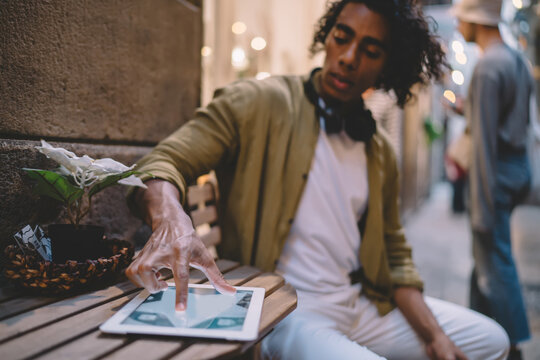 Stylish young man playing game on tablet