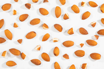 Almond Pieces Broken Shell Nut Flying on White Background