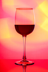 Art photo of a glass with multi-colored lighting