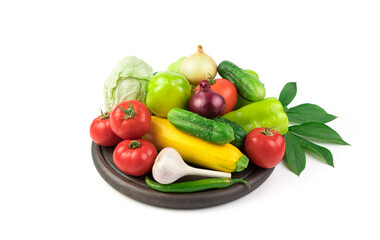 Lots of fresh vegetables on a white background on a wooden Board with a green branch with leaves. Side view. The concept of natural products, proper nutrition.