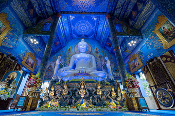 Fototapeta na wymiar Chiangrai, Thailand - September 02, 2020: Big White Buddha Image located in Main Blue Chapel of Wat Rong Suea Ten Temple, The Blue Temple, landmark of Chiangrai Province