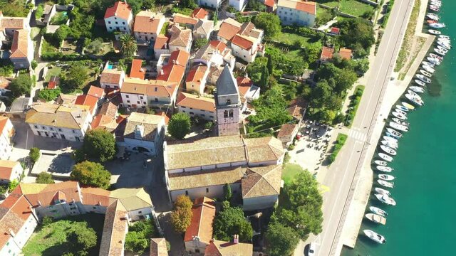 Amazing historic town of Osor, between islands Cres and Losinj, Croatia. Cathedral tower and city center. Drone aerial circle footage.
