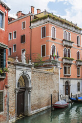 Fototapeta na wymiar Beautiful view of Traditional Venetian buildings along a water channel, Venice, Italy, Europe.