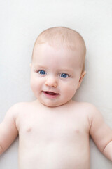 Cute baby girl lying on bed