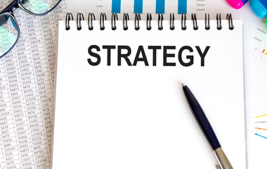 The inscription on a piece of paper is fixed on a tablet for the letter STRATEGY.