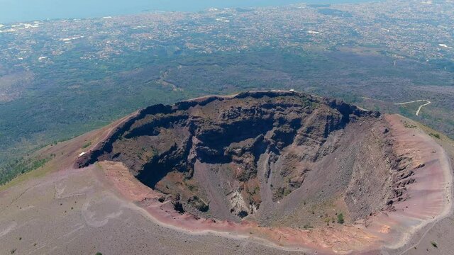 Aerial view of volcano Mount Vesuvius, rough volcanic terrain inside crater on top of mountain - landscape panorama of Naples from above, Italy, Europe