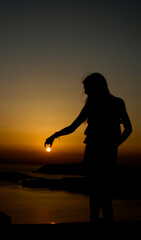 Fototapeta premium silhouette of a woman in the sunset