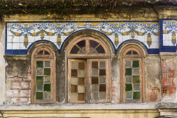 frieze of azulejos and colored glasses on a ruined house in Aveiro, Portugal