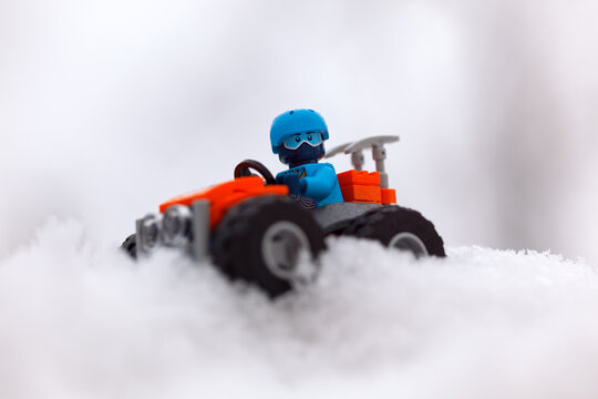 Tambov, Russian Federation - January 28, 2020 Lego All-terrain Vehicle With Explorer Minifigure On Snow Off Road.