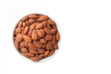 Almonds are in a white cup. Placed on a white floor. Food photography concept. Top view