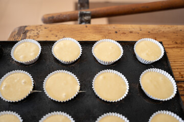 Baker woman pouring dough