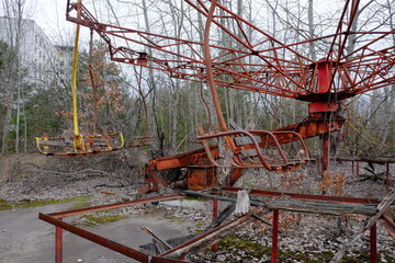 Fototapeta na wymiar An old broken carousel in the abandoned city of Pripyat. Abandoned amusement park.