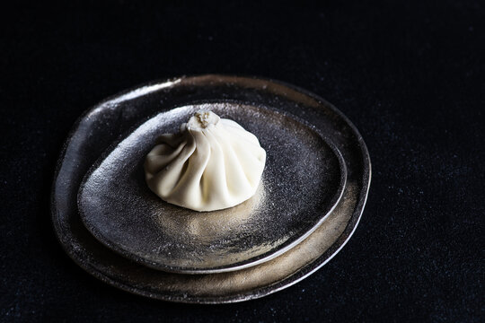 Traditional Georgian khinkali dumpling on a metal dish