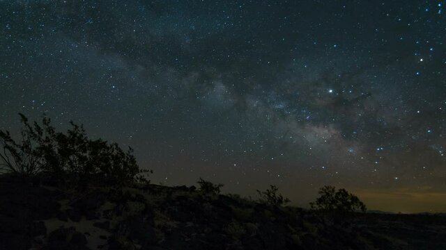  Astro timelapse of Milky Way galaxy tracking over volcanic rocks in Mojave Desert in California