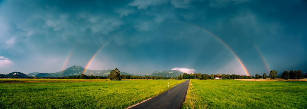 Double rainbow over a road through rural landscape, Salzburg, Austria