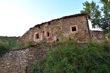 Dry stone walls and houses in the abandoned village of Valtrujal.