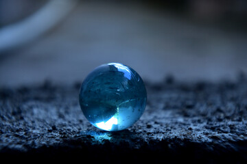 Transparent blue marbles with blur background