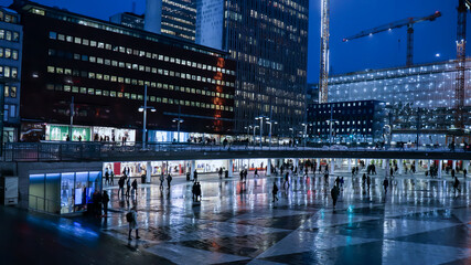 Citylife in the capital of Sweden. People out in the city during Fall. Lots of light, silhouettes and neon singns in the city view. - obrazy, fototapety, plakaty