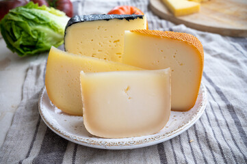 Cheese collection, French fol epi  cheese with many little holes, etorki, tomme noire des pyrenees and ossau iraty cheese