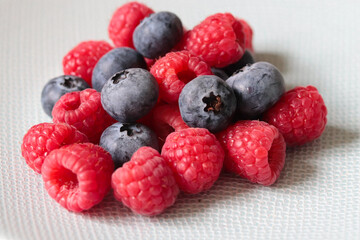 raspberries and blueberries on a plate