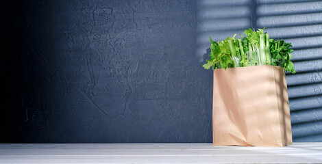 bag with celery on a dark background