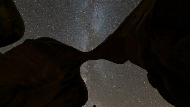  Time lapse tracking shot of Milky Way galaxy through Metate Arch at Devils Garden in Grand Staircase Escalante National Monument in Utah