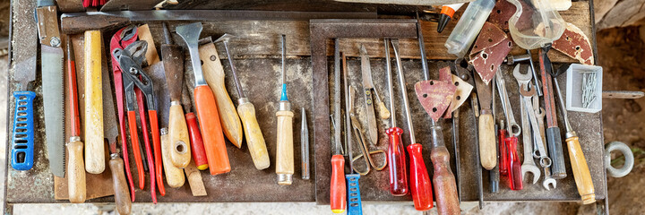 Tools that have been used for renovating an old barn door - obrazy, fototapety, plakaty