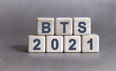 BTS text on wooden cubes on a monochrome background
