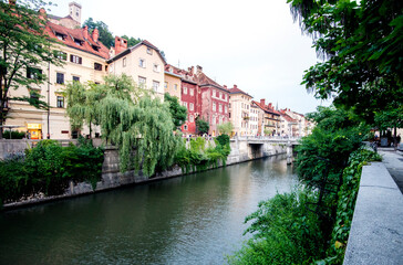 Fototapeta na wymiar River in Ljubljana, Slovenia with residential complexes on one side