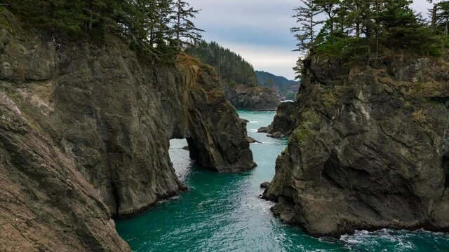  Timelapse of moody sky over natural bridges at rugged coastline at Samuel H. Boardman State Scenic Corridor in Oregon