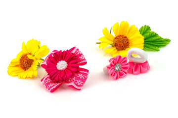 Barrette with pink ribbon and elastic, flowers and green leaf isolated on white background. - 376960762