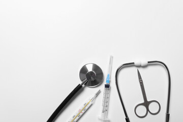medical instruments stethoscope, syringe, thermometer on a white background. pharmacy shopping concept