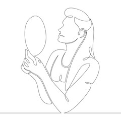 young woman looks in a hand mirror