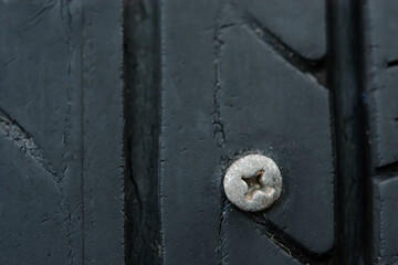 Close up metal screws nails embroidered in tires