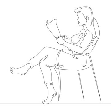 Woman Sitting In A Chair Reading A Magazine