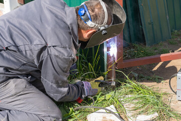 A man works with an inverter welding machine