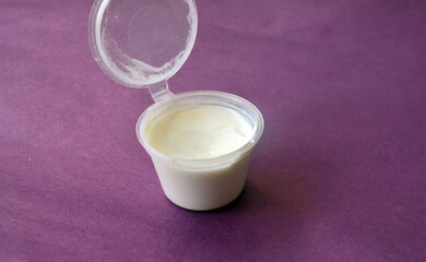 Opened jar of white cream for body and face care