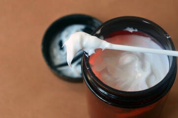 White thick cream on a cotton swab. Body and face care. Cosmetics.