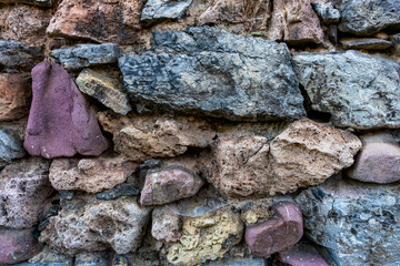 View of old wall of different rocks with various colors