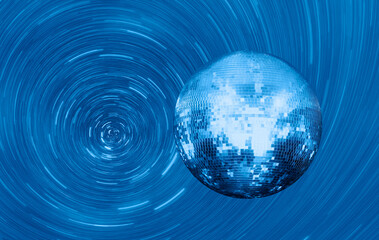 Star trails of party disco mirror ball reflecting colorful lights