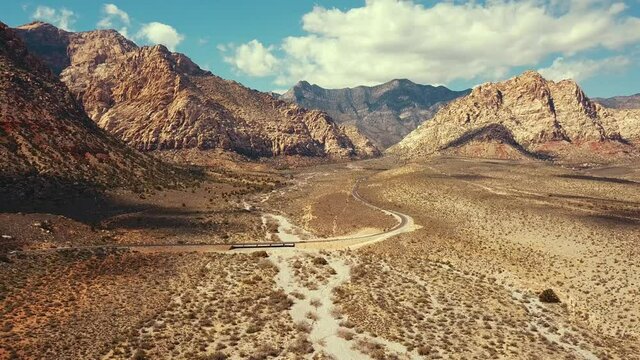Aerial Shot of Road and Reveal Red Rock Canyon in Nevada with Cars