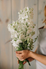 Cheerful young lady with long wavy hair being excited to get bouquet