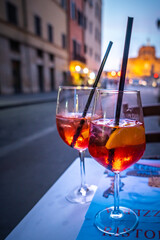 Campari Aperol Spritz cocktail on a table in cafe / restaurant outdoors view of Castle of Holy Angel in Rome.