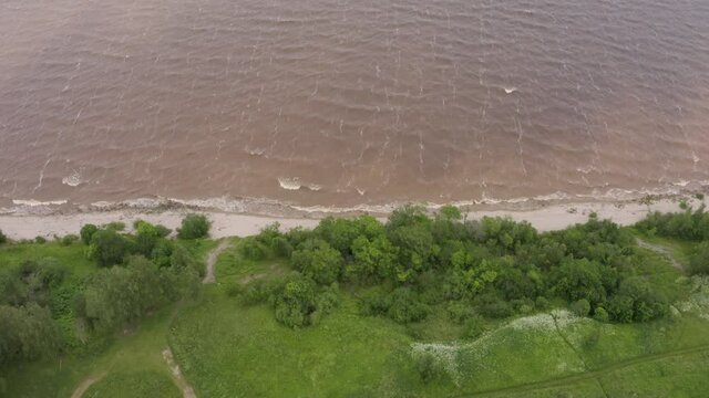 Panoramic aerial view of Lake Ilmen near Veliky Novgorod, natural attractions of Russia. Strong wind and waves on a sunny summer day.