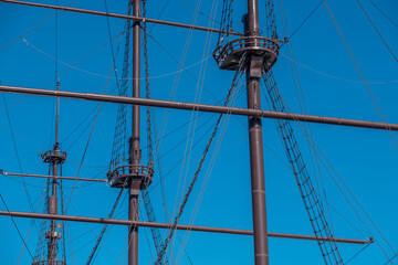 The masts of the old ship against the sky