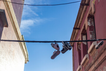 Old sneakers hanging in the street