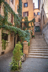 View of old cozy street, steps leading upward in Rome
