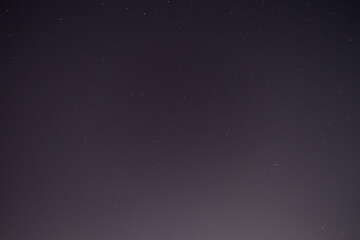 Night starry sky with a lot of stars and constellations in the city.