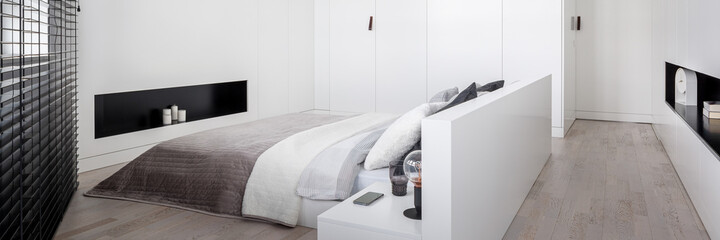 Panorama of simple white bedroom