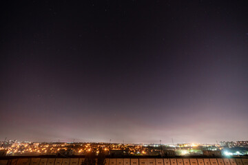 Fototapeta premium Night starry sky with a lot of stars and constellations in the city.